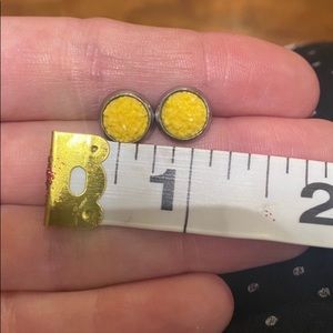 Yellow stud earrings. Rocky texture